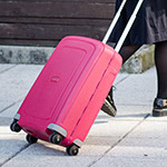Detail of a person pulling a suitcase
