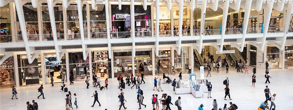 A commercial space with shopfronts and people viewed from above