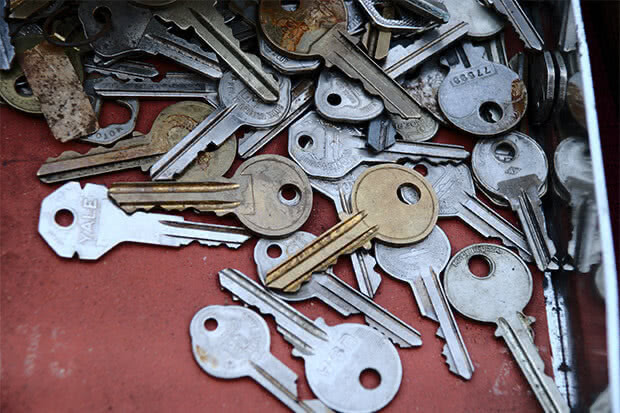 Scattered physical keys on a red background