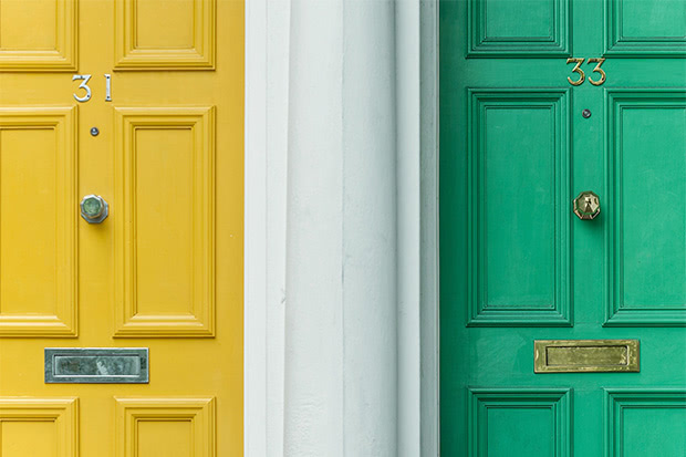 Detail of two similar doors of different color where it/s not sure which one has a smart lock attached