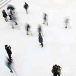 Large number of people walking around a shared space