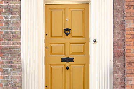 A classic yellow wooden house door